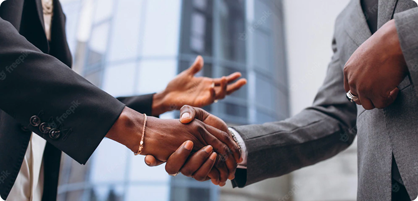 Two business professionals shaking hands in an office setting